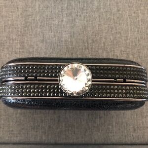 Formal black clutch handbag with snap closure and removeable chain strap